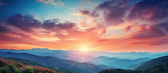 Wall Mural - View of a stunning and colorful sunset in the mountains with a captivating copy space image