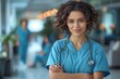 © DachAI - A personable young nurse in scrubs poses with confidence in a bustling hospital corridor, representing care and professionalism