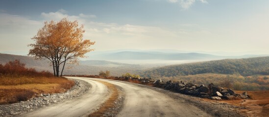 Wall Mural - Late autumn landscape photo with a stone hill and country road featuring a captivating copy space image