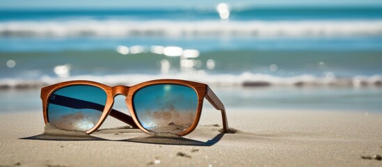 Wall Mural - Sunglasses made of wood resting on the beach with a copy space image