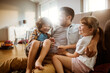 © Vorda Berge - Happy father playing with son and daughter at home