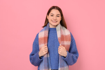 Wall Mural - Beautiful woman in warm scarf on pink background