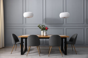 Sticker - Soft chairs, table and vases with plants in stylish dining room