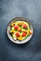 Wall Mural - Risotto with chicken fillet and cherry tomatoes. In a plate. Restaurant dish. Close up.