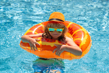 Wall Mural - Child splashing in swimming pool. Active healthy lifestyle, swim water sport activity on summer vacation with child. Child water toys.