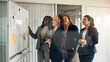 © Flamingo Images - Smiling businesswomen brainstorming together on a whiteboard in a boardroom