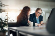 © Flamingo Images - Businesswomen discussing notes during an office meeting in a boardroom
