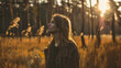 © standret - Woman enjoying nature in a sunlit autumn forest