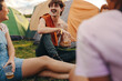 © Jacob Lund - Friends sit outside their festival tents, sharing laughter, drinking beers and creating happy memories