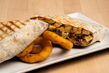 Wall Mural - Halved burrito surrounded by onion rings