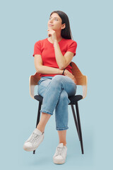 Wall Mural - Young woman sitting and thinking