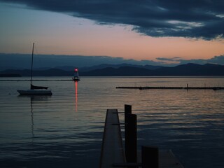 Wall Mural - Summer sunset reflecting on water surface in Vermont