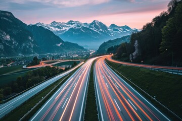 Light trails on the highway in the alps at sunset, europe travel and adventure through scenic mountain roads