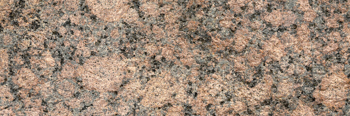 Wall Mural - Granite texture. Natural pink granite with a grainy pattern. Stone background. Solid rough surface of rock. Durable construction and decoration material. Close-up.