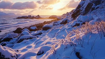 A snowy beach with a rocky shoreline. The sun is setting in the distance. The sky is a mix of blue and orange. The snow is covering the ground and the rocks. The scene is peaceful and serene
