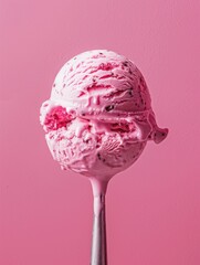 Wall Mural - A scoop of pink ice cream is on a silver spoon. Concept of indulgence and enjoyment, as the viewer can almost taste the sweet