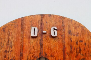 House number six on brown wooden door