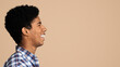© Prostock-studio - Happy smiling african guy profile portrait. Black man looking aside at copy space