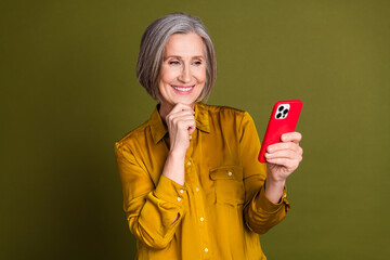 Poster - Photo of good mood thoughtful lady dressed blouse reading modern device empty space isolated khaki color background