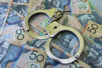 Wall Mural - aud australian dollar with handcuff, finance crime concept