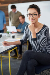 Wall Mural - Portrait, woman and smile in office for creative project, meeting and workshop with team. Modern workplace, female worker and planning for career, content creator and designer with notebook by table