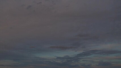 Wall Mural - The evening sky gradually darkens. White clouds at sunset move slowly across the sky as night falls. Calm, nostalgic background with a feeling of slight sadness and sadness.