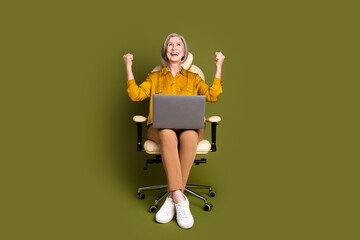 Canvas Print - Full length photo of cheerful attractive lady dressed blouse winnin game modern device empty space isolated khaki color background