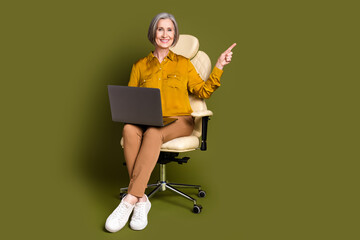 Sticker - Full length photo of cheerful attractive lady dressed blouse working device pointing empty space isolated khaki color background