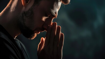 Christian Man Praying in Closeup on Dark Background