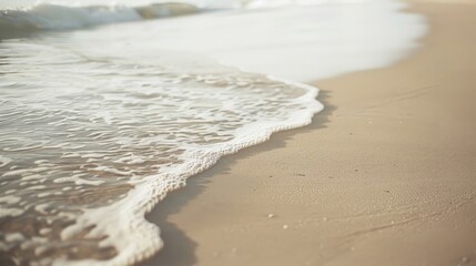 Wet sand on the beach and soft ocean wave with white foam landscape, background