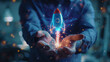 © Ekkarat_Studio - A man holding hands with a rocket and space icon on a hologram background, representing the growth of a startup business concept. Strategic planning and business success.