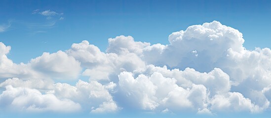 Wall Mural - A nature background featuring puffy white clouds against a clear blue sky with copy space image available