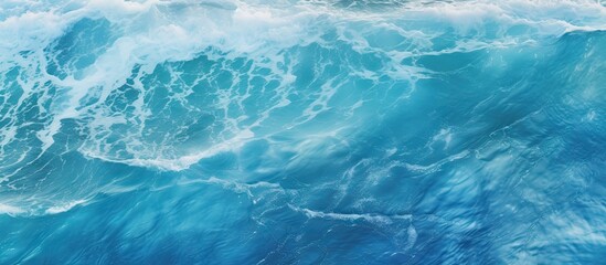 Wall Mural - A top down view of ocean waves creating water patterns suitable as a background image with copy space