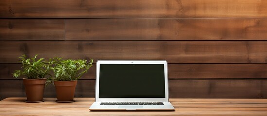 Poster - An isolated laptop with a blank screen is placed on a wooden table providing a mockup or template for your text Copy space image with clipping paths included for background and device screen