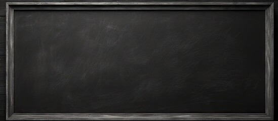 Wall Mural - A horizontal blackboard with a black frame depicting a chalkboard background with a textured appearance that can be used as a copy space image