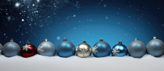 Wall Mural - a blue background adorned with christmas balls and stars perfect for copy space image