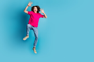 Poster - Full length portrait of nice young man scared jump wear t-shirt isolated on blue color background