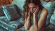 © HY - Stressed pregnant woman with long brunette hair, sitting on a couch with hands on head, denim jacket, living room setting