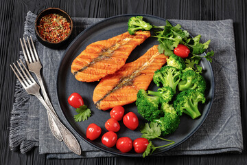 Wall Mural - grilled salmon steaks with broccoli and tomatoes