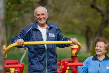 senior couple practicing exercise outdoors