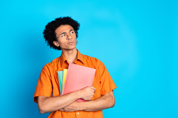 Poster - Photo of funky unsure guy dressed orange shirt eyeglasses reading novels looking emtpy space isolated blue color background