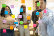 © ADDICTIVE STOCK - Diverse Team Brainstorming With Sticky Notes In Office