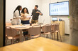 © ADDICTIVE STOCK - Collaborative Team Reviewing Data in Modern Office Space