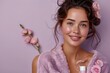 © Tharu - Girl holding skincare cream bottle. beauty products ad, copy space for text. Close up smiling beautiful woman wearing towel holding a cream tube. product photograph of purple cream tube