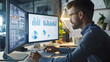 © Gita - A data analyst examines financial charts and graphs on dual monitors in a modern office. The workspace is well-lit and organized, reflecting a professional and focused environment.