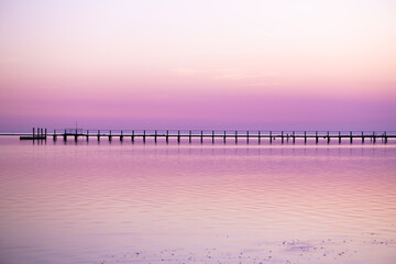 Wall Mural - Sunset sea with wooden pier and boat on background