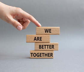 Wall Mural - We are better together symbol. Wooden blocks with words We are better together. Beautiful grey background. Businessman hand. We are better together concept. Copy space.