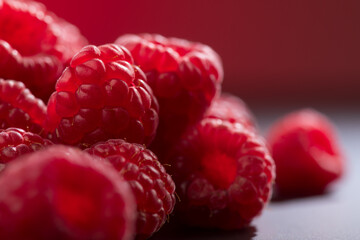 Canvas Print - Raspberry fresh berries closeup, ripe fresh organic Raspberries over dark background, macro shot. Harvest concept, border design 