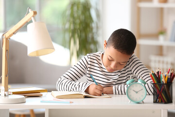 Poster - Little African-American boy doing lessons at home