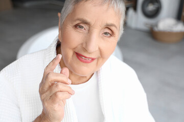 Canvas Print - Senior woman with cream in bathroom, closeup